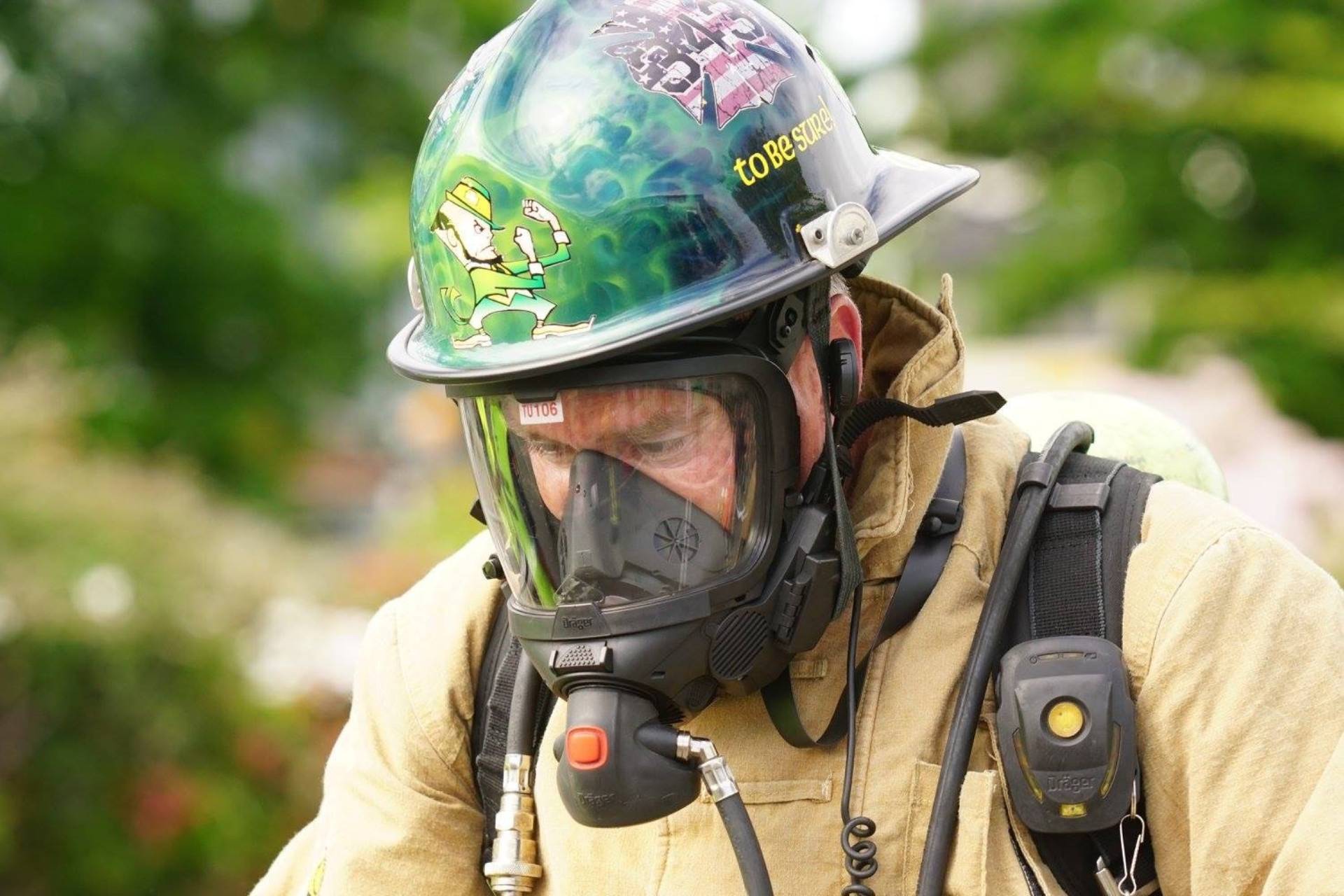 Firefighter wearing full protective gear and a helmet